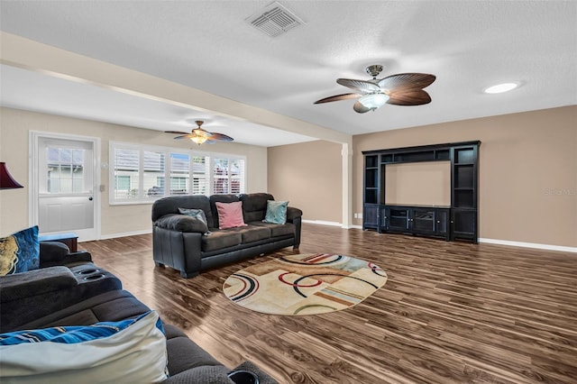 living room with ceiling fan and dark hardwood / wood-style floors