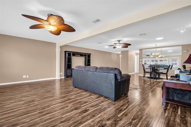 living room featuring dark hardwood / wood-style floors, beamed ceiling, and ceiling fan with notable chandelier