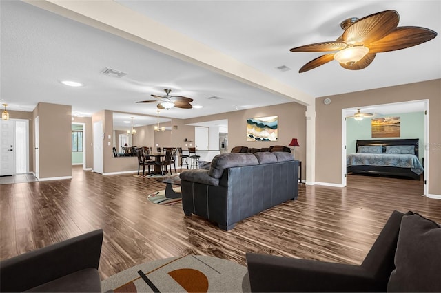 living room with dark hardwood / wood-style floors and a notable chandelier