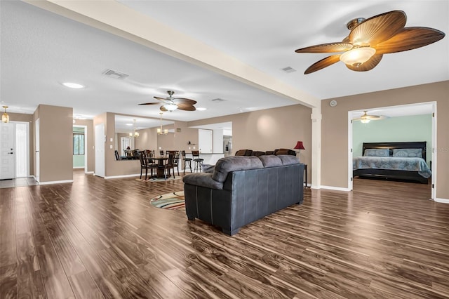 living room with dark hardwood / wood-style flooring and a notable chandelier