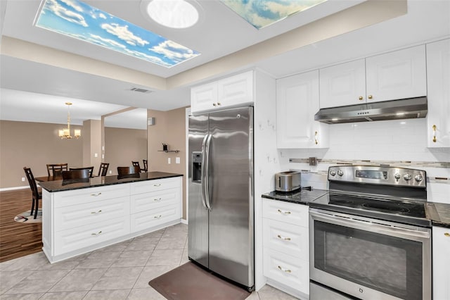 kitchen with decorative light fixtures, white cabinetry, stainless steel appliances, a notable chandelier, and light tile patterned flooring