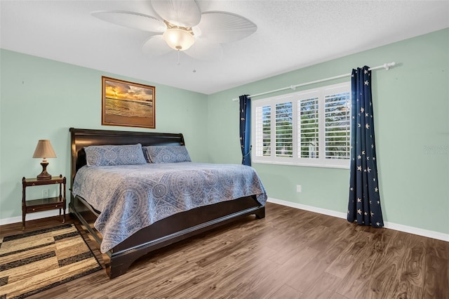 bedroom with ceiling fan and wood-type flooring