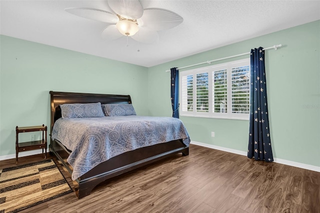 bedroom with ceiling fan and wood-type flooring