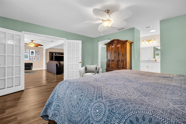 bedroom with ceiling fan, dark hardwood / wood-style flooring, connected bathroom, and sink