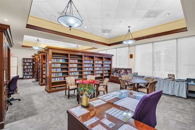 carpeted dining space with a tray ceiling and a paneled ceiling