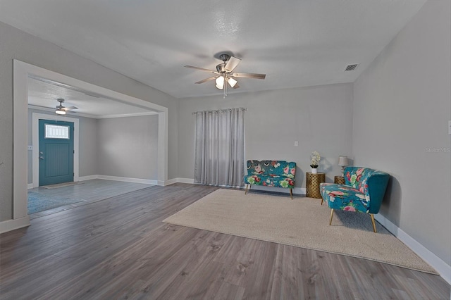 living area with hardwood / wood-style floors, a textured ceiling, and ceiling fan