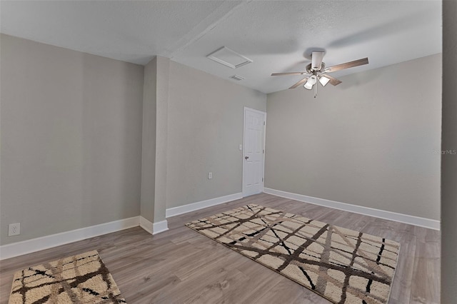 unfurnished room featuring light hardwood / wood-style floors and a textured ceiling