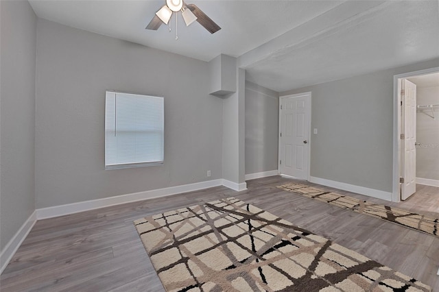 spare room with ceiling fan and hardwood / wood-style flooring