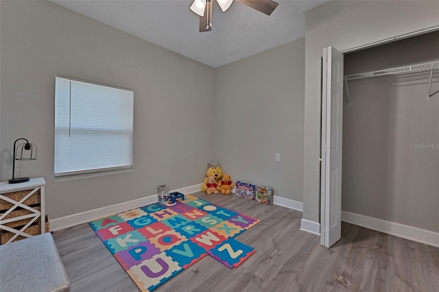 game room with hardwood / wood-style flooring and ceiling fan