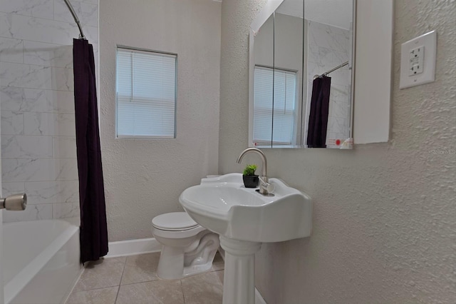 bathroom with shower / tub combo with curtain, tile patterned flooring, and toilet