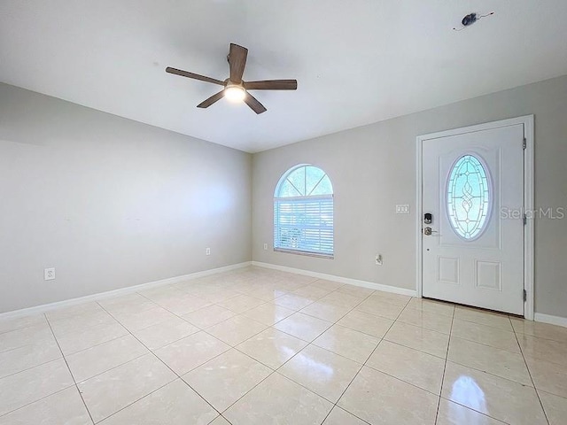 foyer entrance with ceiling fan and light tile patterned floors