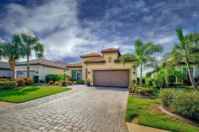 mediterranean / spanish-style house with a front lawn and a garage