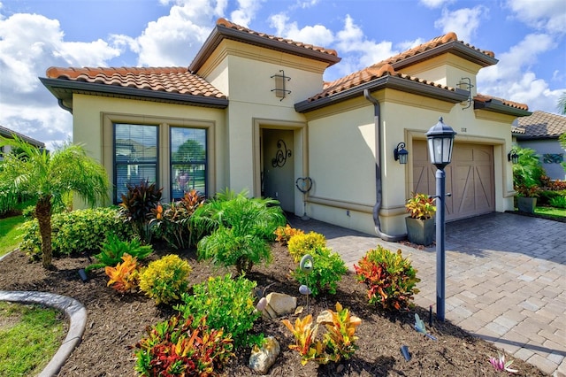 mediterranean / spanish home featuring a garage