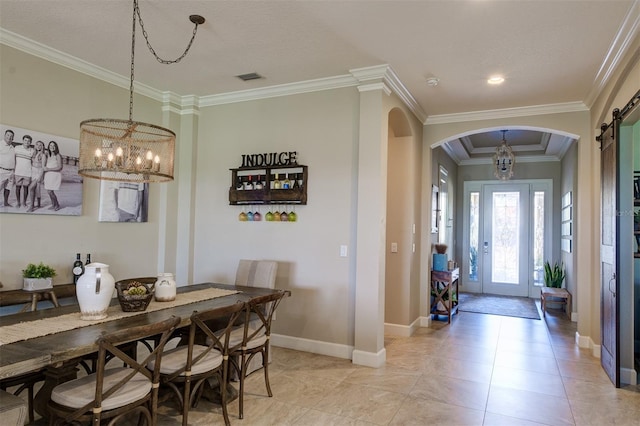 dining room featuring light tile patterned floors, a barn door, crown molding, and a notable chandelier