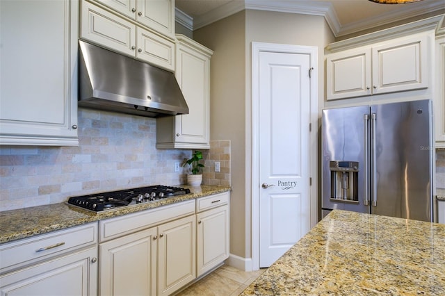 kitchen featuring decorative backsplash, light stone counters, ornamental molding, stainless steel appliances, and light tile patterned flooring