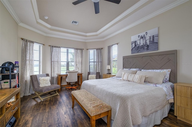 bedroom with ceiling fan, dark hardwood / wood-style flooring, a raised ceiling, and multiple windows