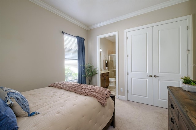 bedroom with a closet, ornamental molding, light carpet, and ensuite bath