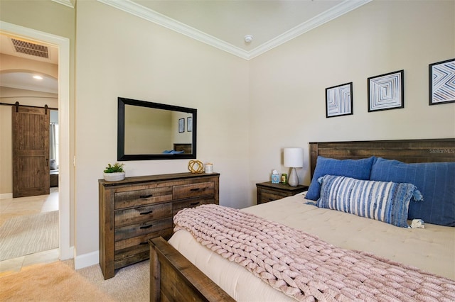 carpeted bedroom with a barn door and ornamental molding