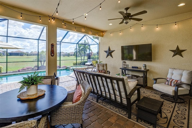 sunroom featuring a pool and ceiling fan