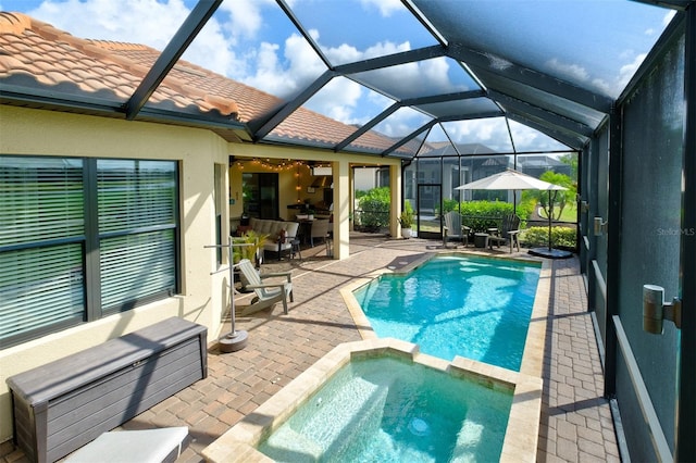 view of swimming pool featuring a lanai, an in ground hot tub, and a patio