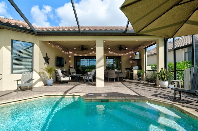 view of pool with ceiling fan, area for grilling, a lanai, and a patio