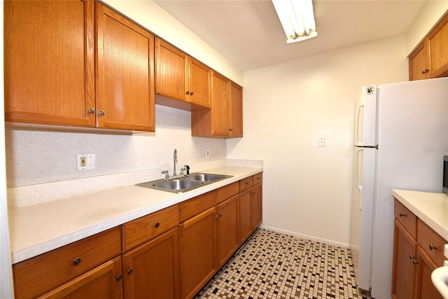 kitchen featuring white fridge and sink