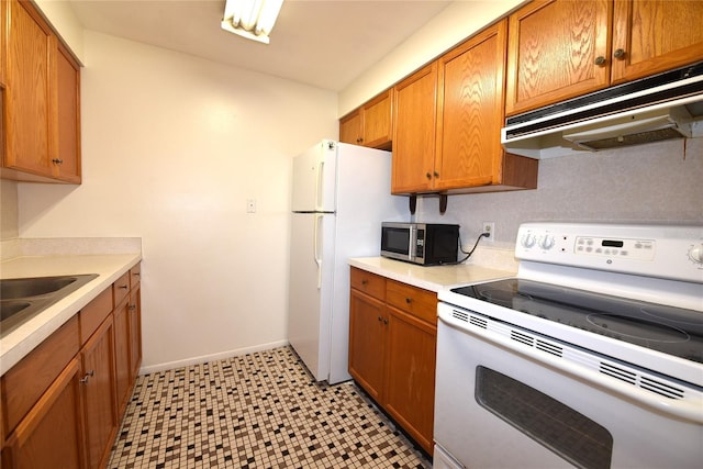 kitchen featuring white appliances and sink