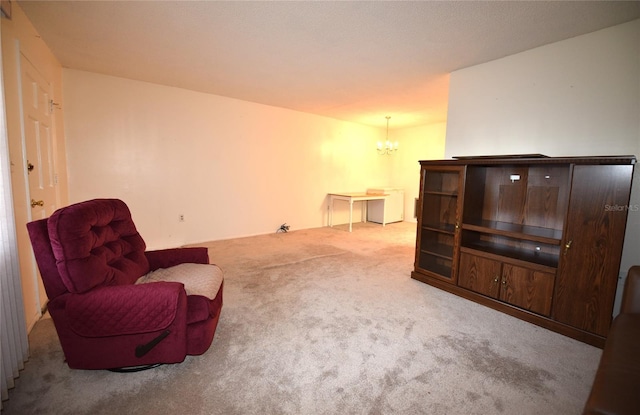 sitting room featuring an inviting chandelier and carpet floors