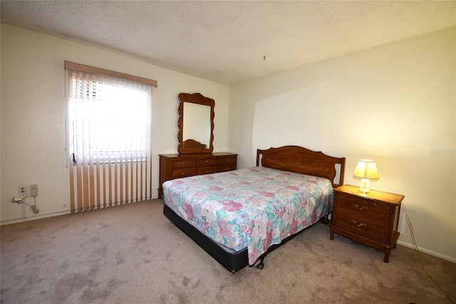 bedroom featuring light colored carpet and a textured ceiling