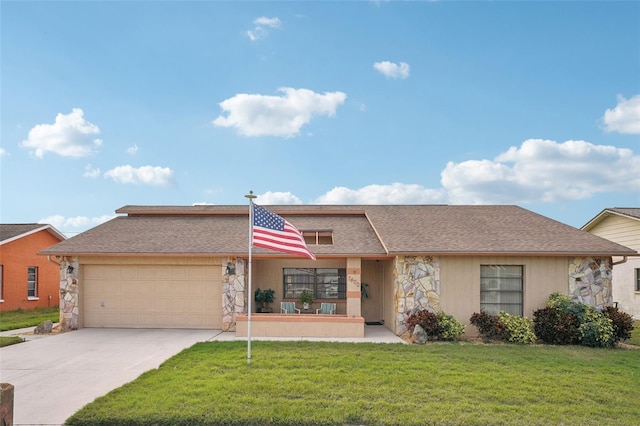 view of front of property with a garage and a front lawn