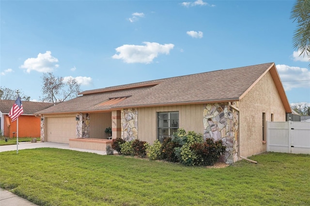 ranch-style house featuring a front yard and a garage