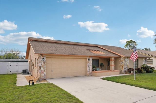 ranch-style house featuring cooling unit, a garage, and a front yard