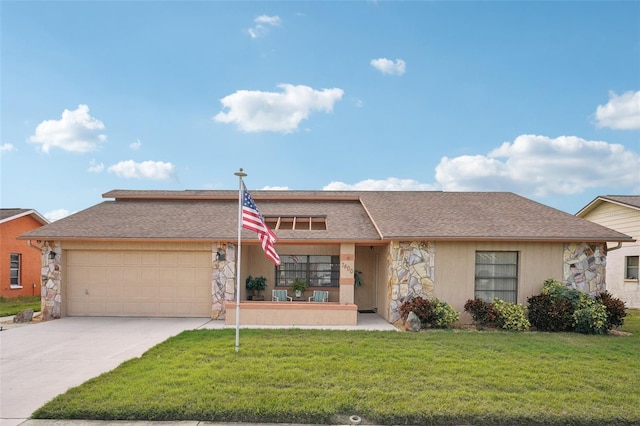 single story home with a garage and a front lawn