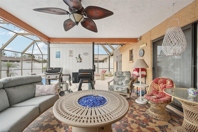 sunroom / solarium featuring ceiling fan