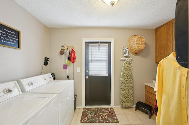 laundry area with light tile patterned flooring, separate washer and dryer, and a textured ceiling