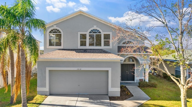 view of front facade with a garage and a front lawn