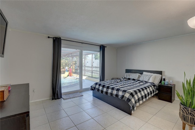 tiled bedroom with access to exterior and a textured ceiling