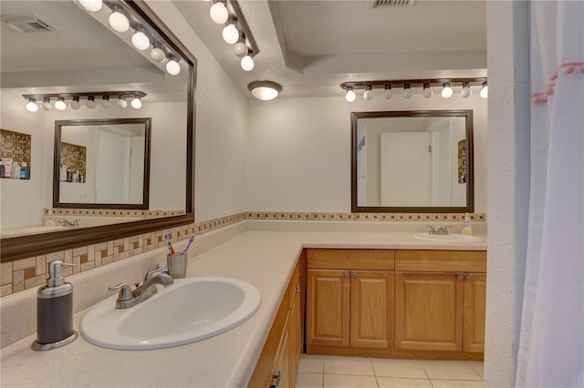 bathroom with vanity, backsplash, and tile patterned floors