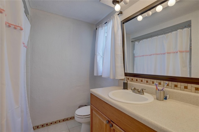 bathroom featuring toilet, vanity, and tile patterned floors