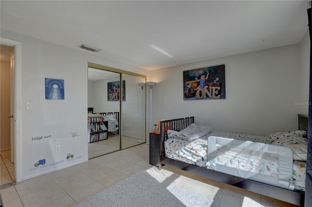 tiled bedroom with a closet