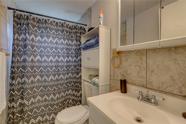 bathroom featuring vanity, curtained shower, and toilet