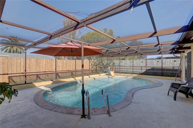 view of swimming pool featuring a lanai and a patio area