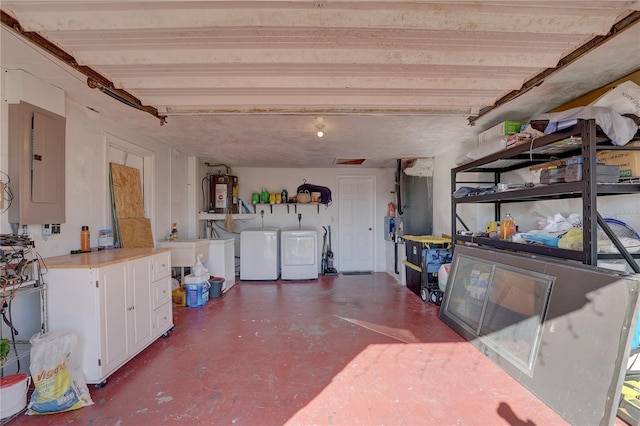 interior space featuring water heater, concrete flooring, electric panel, and washing machine and clothes dryer