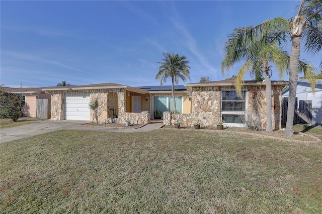 ranch-style home featuring solar panels, a garage, and a front lawn