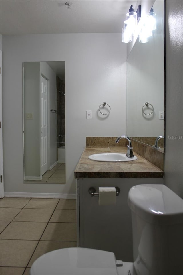 bathroom with tile patterned floors, vanity, and toilet