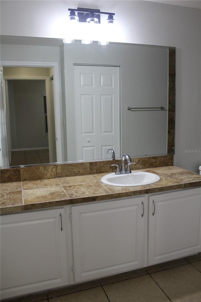 bathroom with tile patterned flooring and vanity