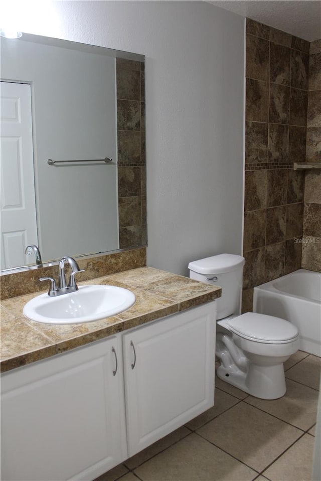 full bathroom with toilet, shower / tub combination, vanity, and tile patterned floors