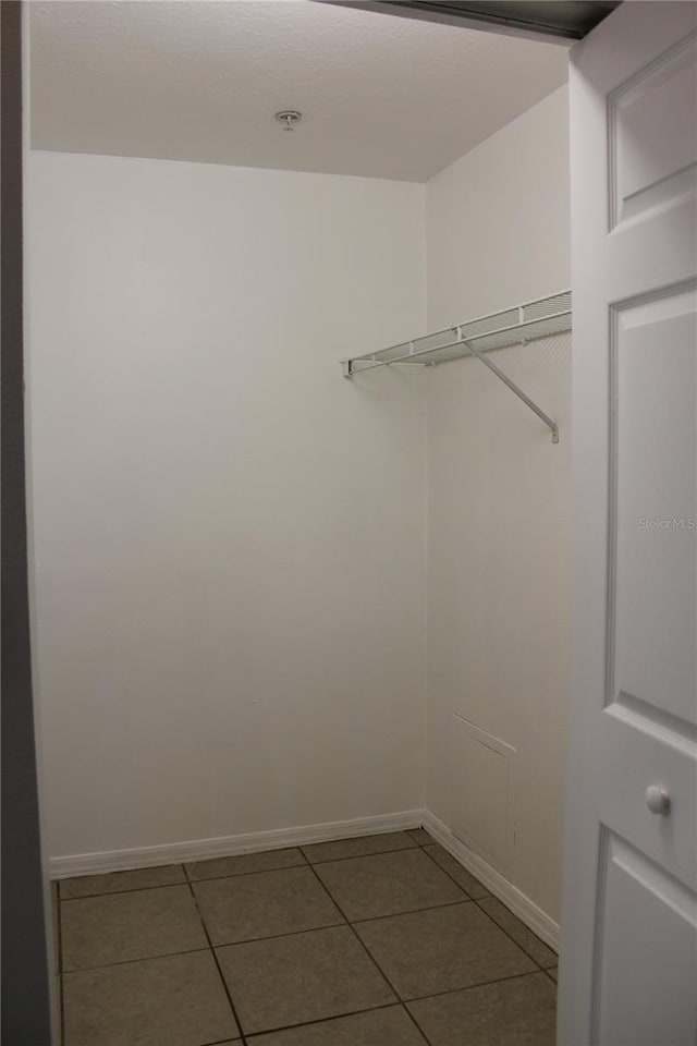 spacious closet with tile patterned flooring