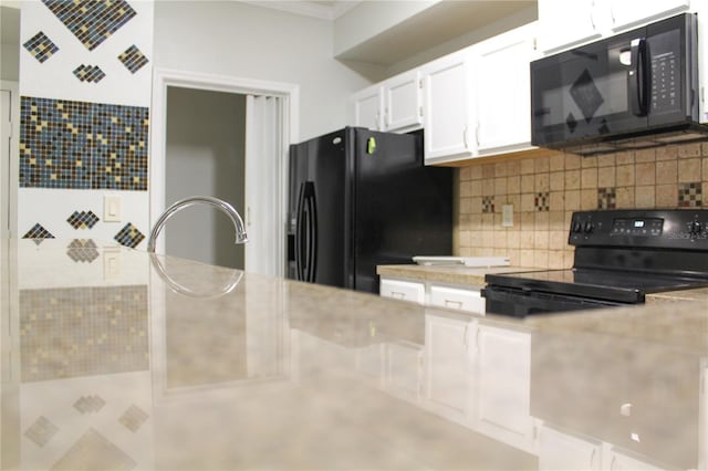 kitchen with backsplash, white cabinetry, and black appliances