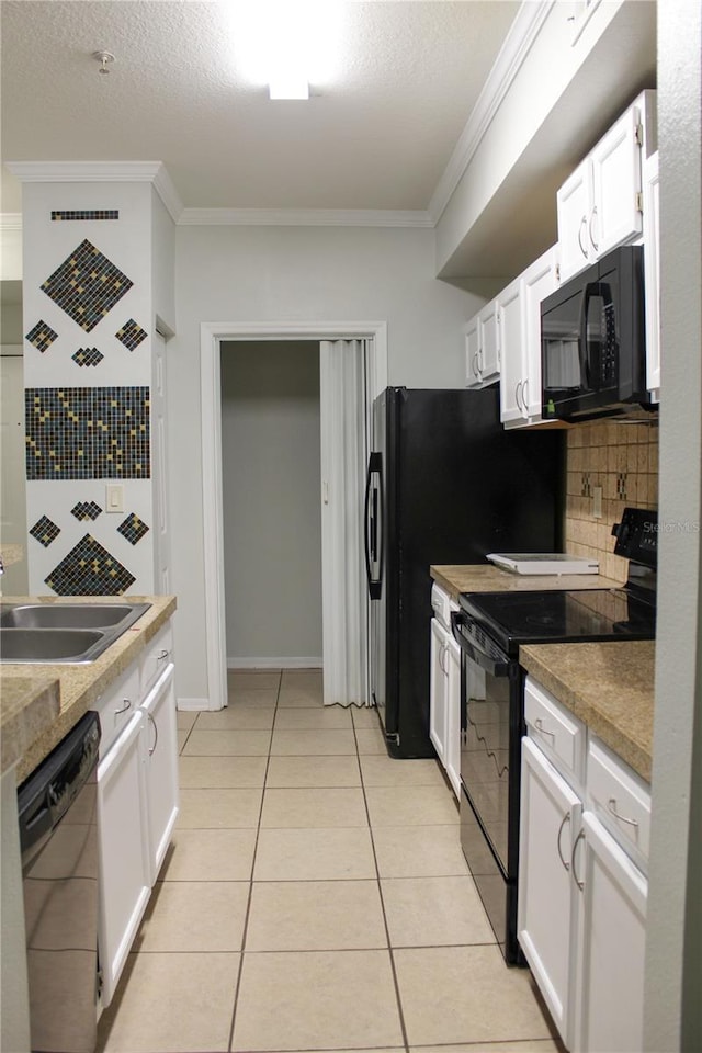 kitchen featuring a textured ceiling, crown molding, black appliances, light tile patterned floors, and white cabinetry